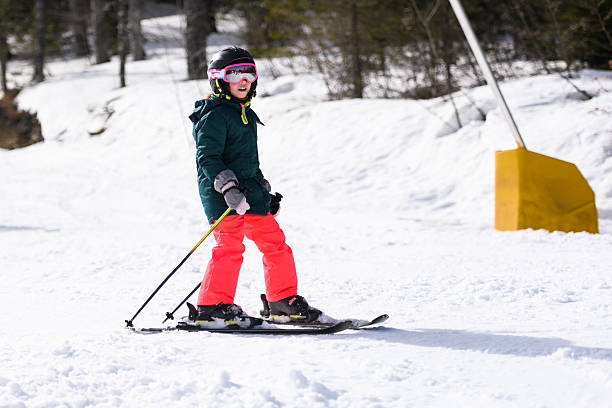 istock Young girl skiing downhill on sunny winter day 2237584992