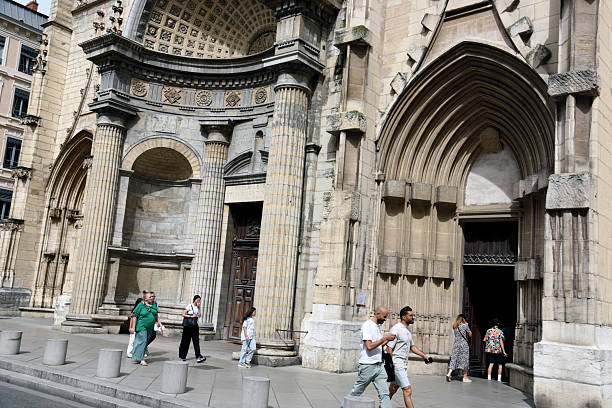 The Church of Saint-Nizier is a church in the Presqu'île district of Lyon. Begun in the 14th century and only completed in the 19th century, the church contains a variety of architectural styles, ranging from the neo-Gothic spire to the classical Renaissance facade. Captured during spring seaoson with some people next the main entrance.
