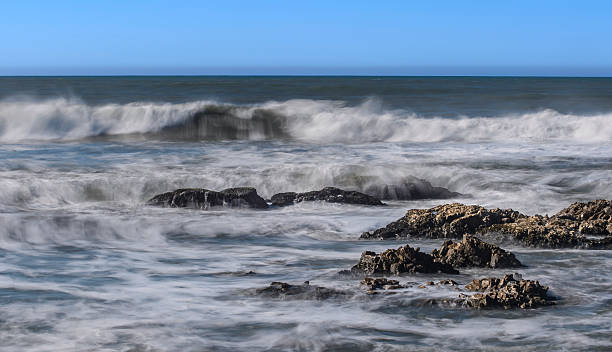 istock Ocean Waves Crashing on Rocky Shore 2237588127