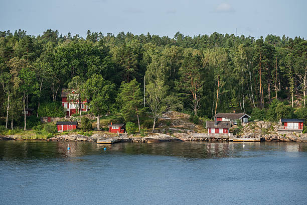 istock Red houses on rocky coast surrounded by trees.. 2237588134