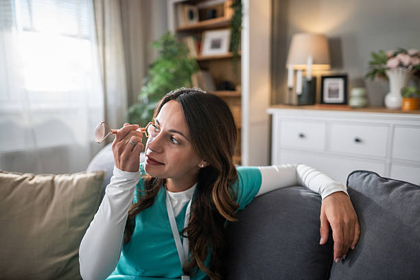 istock Female nurse relaxing at home using jade roller for self-care 2237590922