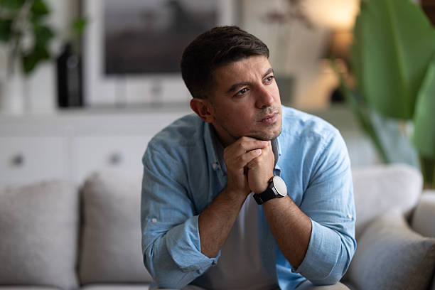 istock Worried man thinking of his problems at home. 2237594095