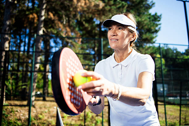 istock Senior player serving ball during padel game 2237594970