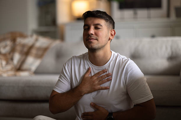 istock Young man meditating at home 2237595191