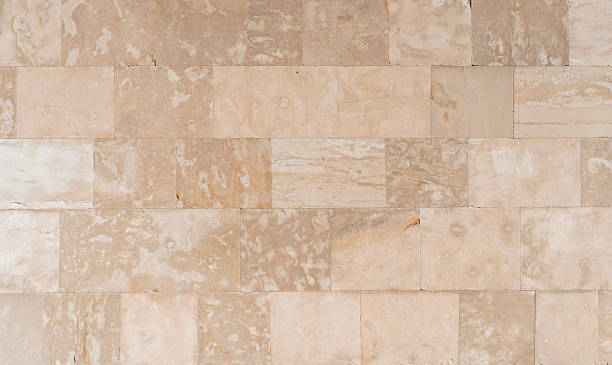 istock Antique ancient stone wall masonry texture background. Old wall made of beige stone blocks 2237599773