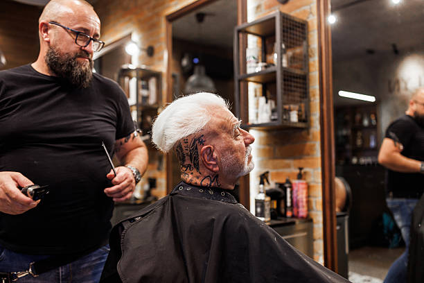 istock Professional barber and elderly male client in a modern barbershop 2237599903