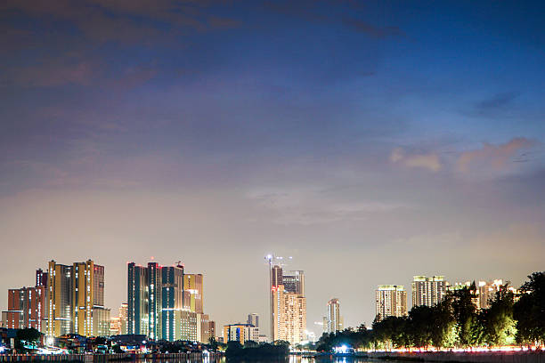 Illuminated Urban Panorama Reflecting on Calm Waterways Under a Twilight Sky Showcasing a Modern Metropolis Skyline at Dusk with Towering Buildings and Subtle City Lights creating a Dreamy Ambiance