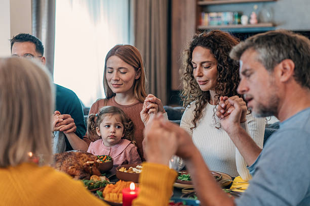 istock Family holding hands and praying on the table 2237602084