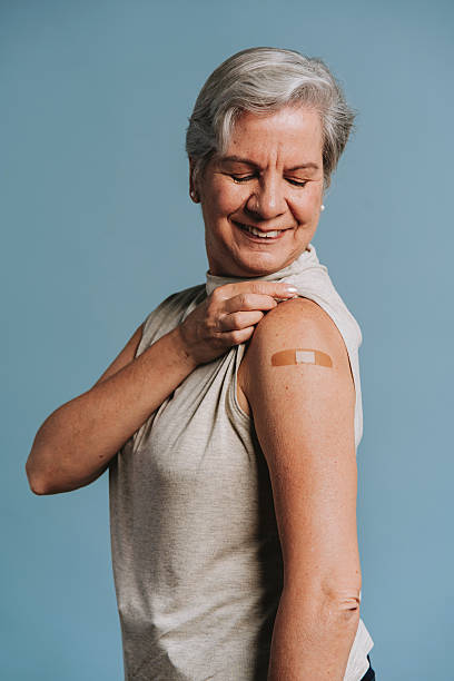 istock Senior woman showing bandage after vaccination 2237603361