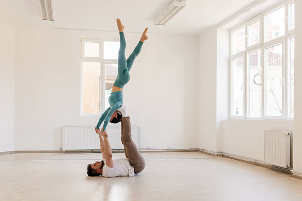 A couple doing acro yoga