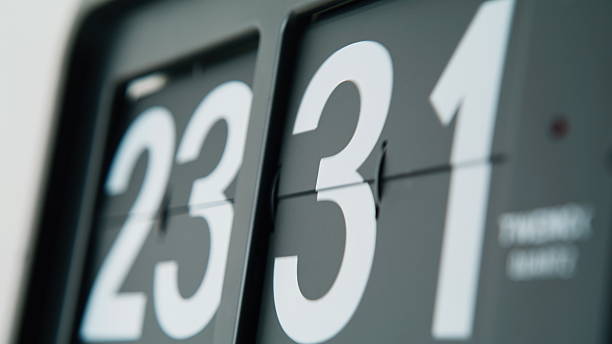 istock Flip clock rotating digits showing time flowing closeup. Black white panels 2237606976
