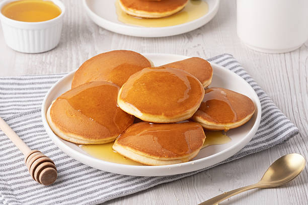 istock Delicious fluffy pancakes with syrup served on a white plate for breakfast 2237607804