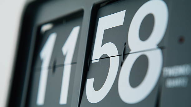 istock Flip clock shifting numbers in mechanical rhythm indoors closeup. Macro time 2237609504