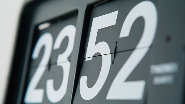 istock Clock display flipping downward marking passage of time indoors closeup. 2237609587