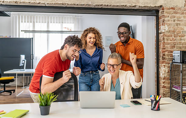 istock Diverse business team celebrating success looking at laptop 2237612529