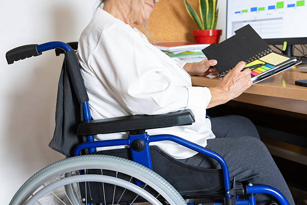 istock Senior woman with disability working at office desk 2237615862