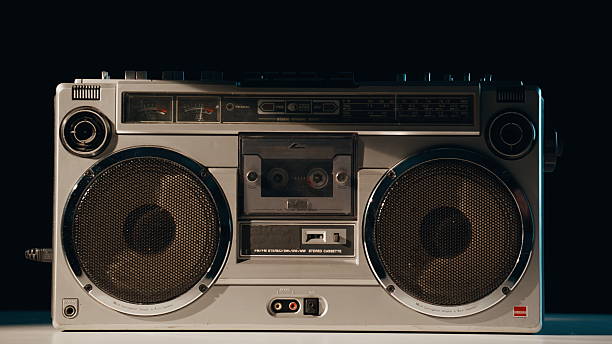 istock Hand pressing button boombox standing in evening light closeup. Listener turning 2237617806