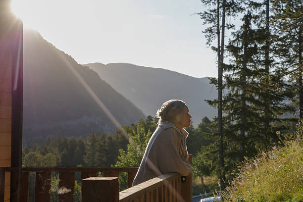 istock Mature woman enjoys sunrise from deck 2237619157