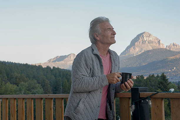 istock Mature man enjoys hot beverage on chalet deck 2237619173