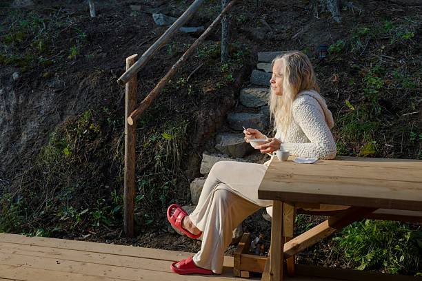 Woman enjoys breakfast on outdoor deck