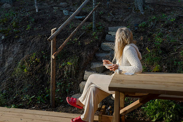 Woman enjoys breakfast on outdoor deck