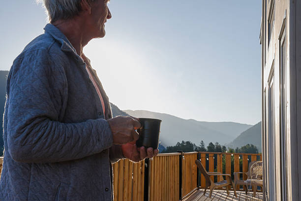 istock Mature man enjoys hot beverage on chalet deck 2237619185