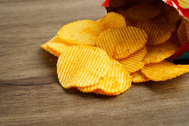 istock Potato chips in open bag, delicious BBQ seasoning spicy for crips, thin slice deep fried snack fast food. 2237621123
