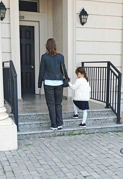 istock Mother and daughter walking together outside 2237621471