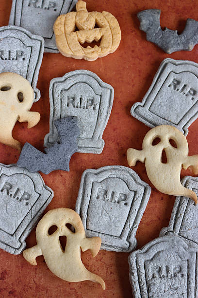 istock Image of haunted halloween cookie / homemade gravestones, ghosts, pumpkins, spider biscuits styled, mini cemetery 2237621882