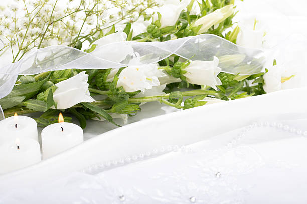 White flowers with candles on satin and lace
