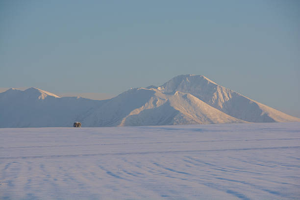 Snowfields and snowy mountains at dusk in winter