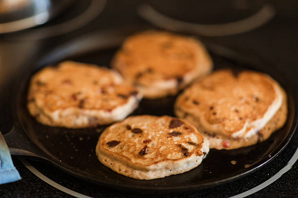 A Homemade Raspberry, Chocolate Chip Protein Pancake Cooking in a Cast Iron Pan