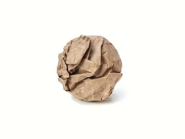 A crumpled brown paper ball isolated on white background. Element for creative design