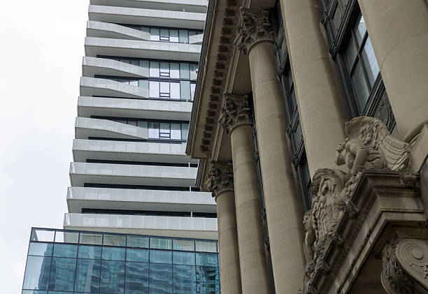 A skyscraper and the Toronto Harbour Commission Building show a contrast between modern and old architecture