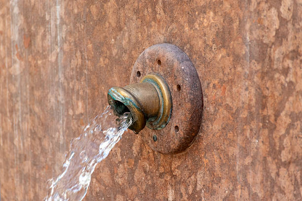 istock Old Brass Fountain Spout with Water 2237653821