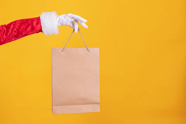 istock santa claus hand with shopping bags 2237655258
