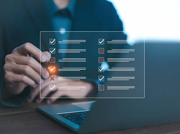 istock Business person reviewing digital checklist on laptop, symbolizing task evaluation, project management, performance review, and productivity analysis in modern digital workflow. 2237656589