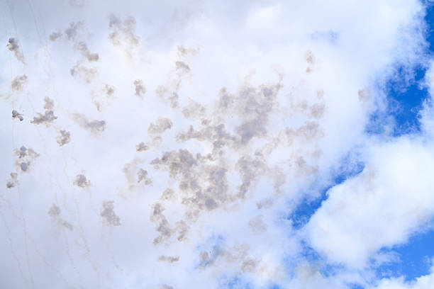 A textured view of gray clouds scattered across a blue sky, perfect for use as backgrounds. The subtle contrast between the gray clouds and the vibrant blue sky creates a visually appealing and dynamic effect, suitable for various design and artistic projects. This natural sky texture captures the serene yet dramatic elements of weather patterns.