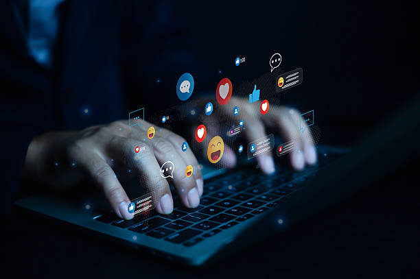 istock Hands typing on laptop with floating social media icons, representing digital communication, online interaction, social network engagement, and marketing technology concept. 2237657448