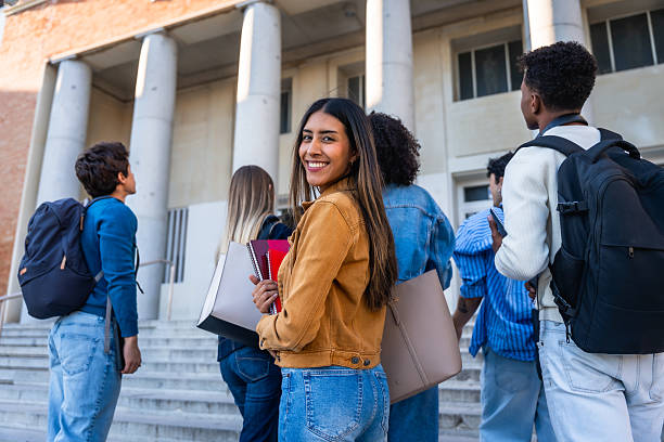istock Diverse students walking to university campus building 2237658679