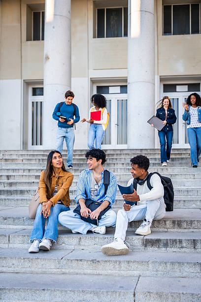istock Diverse students talking and walking on university campus stairs 2237658713