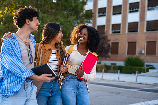 istock Diverse students walking and laughing on university campus 2237658761