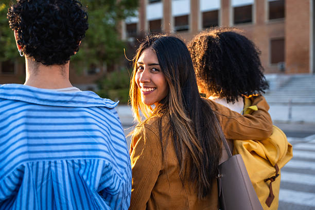 istock University students walking on campus and smiling at sunset 2237658765