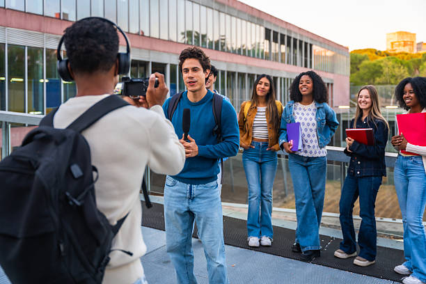 istock University students recording an interview for campus media 2237658806