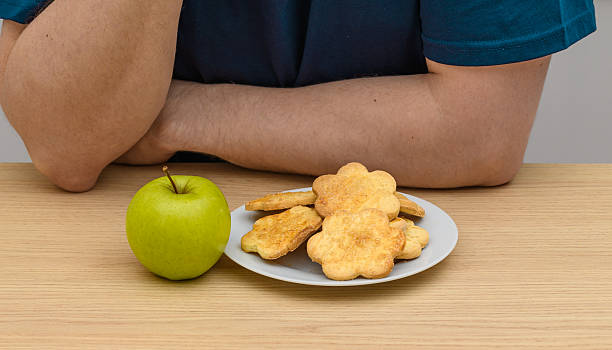 Shortbread butter cookies with sugar on a plate next to a beautiful green apple