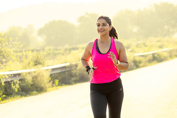 Indian Woman Jogging in early morning on rad