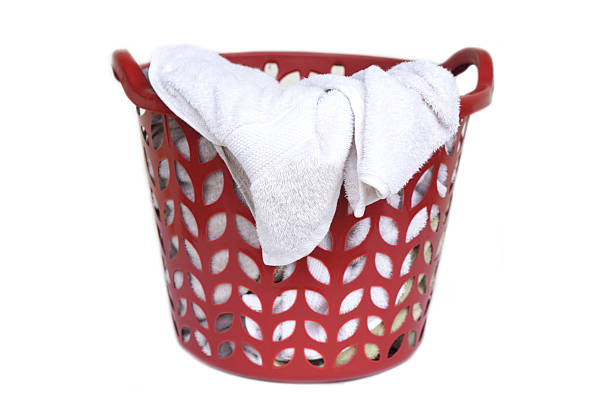 Photo of the side of the clothes basket is made of light green plastic with a hole pattern that makes it unique.