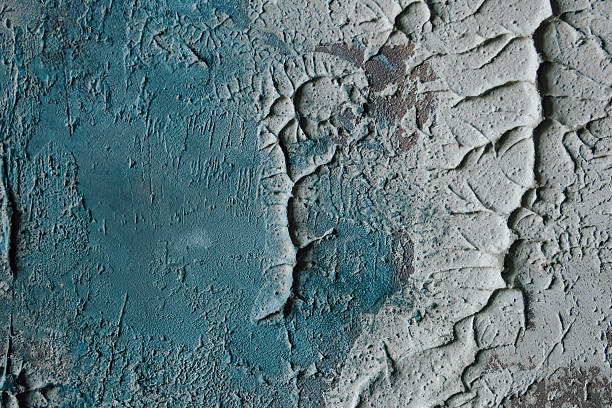 Textured surface showing blue and gray patterns in a close up view of an old wall