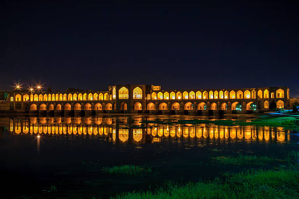 Isfahan, Iran - 15th june, 2022: Old Khajoo bridge at night, across the Zayandeh River in Isfahan, Iran.