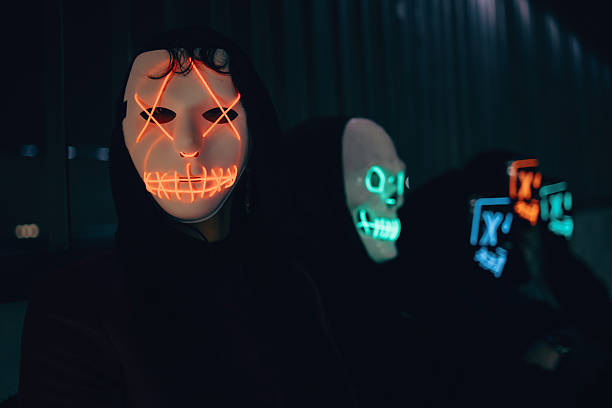 istock Individuals wearing neon-lit masks in a dark atmospheric urban setting 2237665151